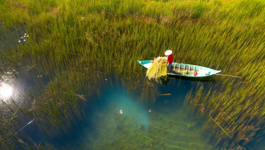 a small boat floating on top of a body of water