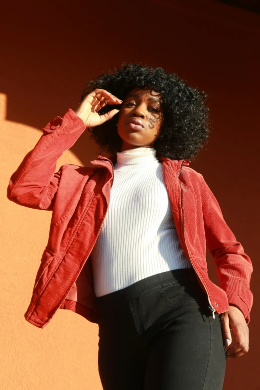 a woman in black pants and white shirt and a red jacket