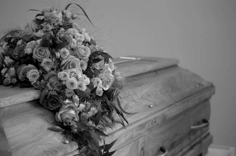 an old casket with a bunch of flowers on it