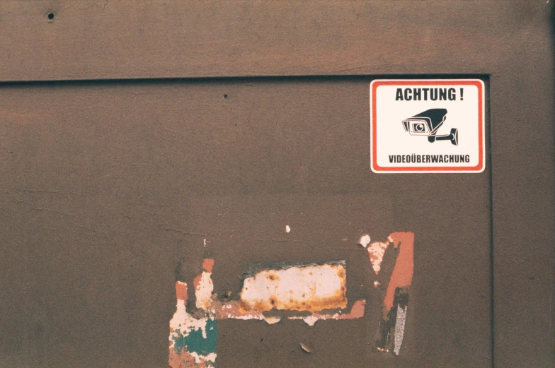 a dirty street scene with a car and a sign