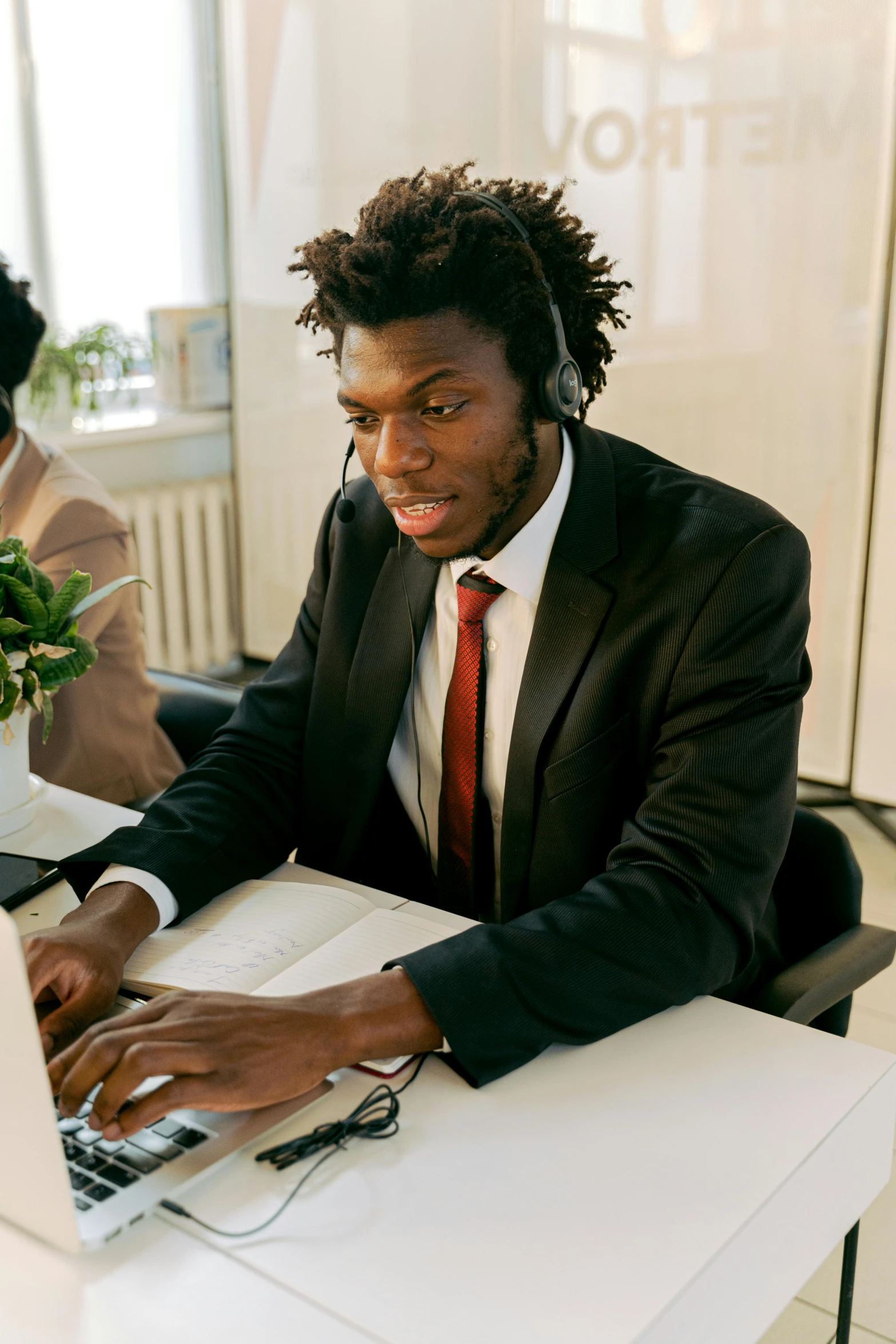 a person is sitting in front of a laptop