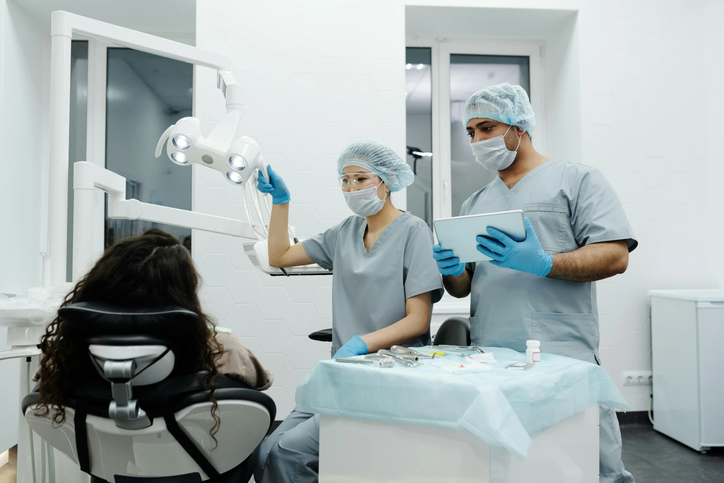 people standing in a doctors room holding soing