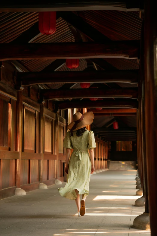 a woman is walking in an alley near wooden walls