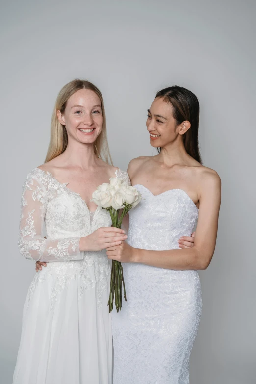 two young ladies standing in front of each other, posing for a pograph