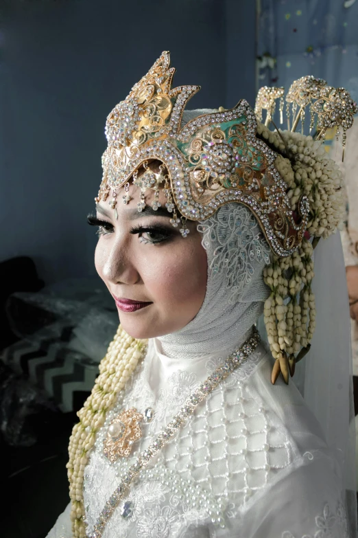 a woman with a veil wearing an elaborate head piece