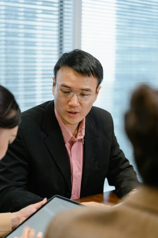 a man and woman are sitting at a table talking