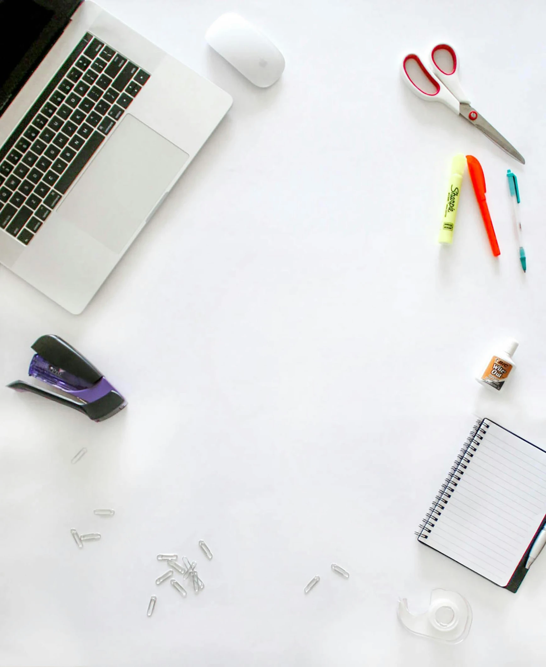 a laptop sits on the desk next to some school supplies