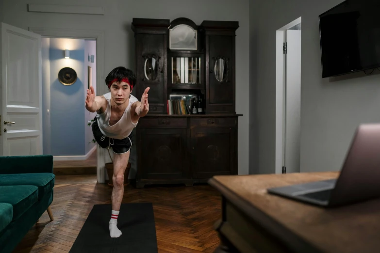 a person is doing a trick while standing in the living room