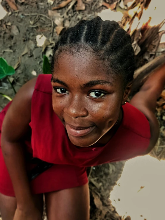 a woman with a top knot smiling for a picture