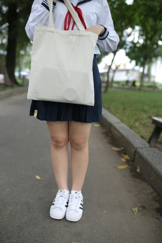 a girl holding a tote bag in her hands