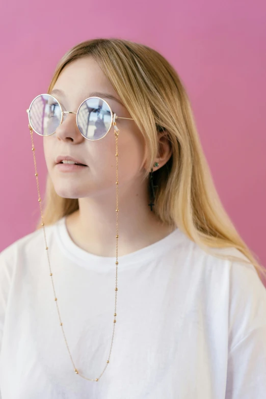 a beautiful young lady wearing sunglasses and standing