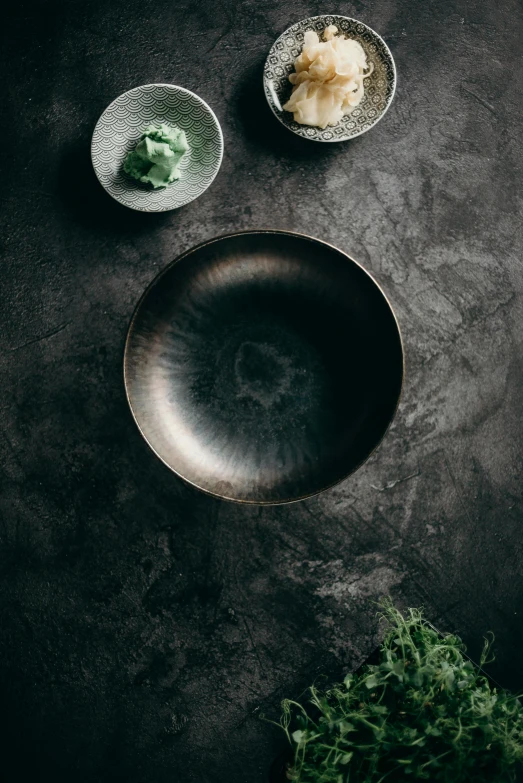 two dishes with various kinds of vegetables are sitting on a gray table