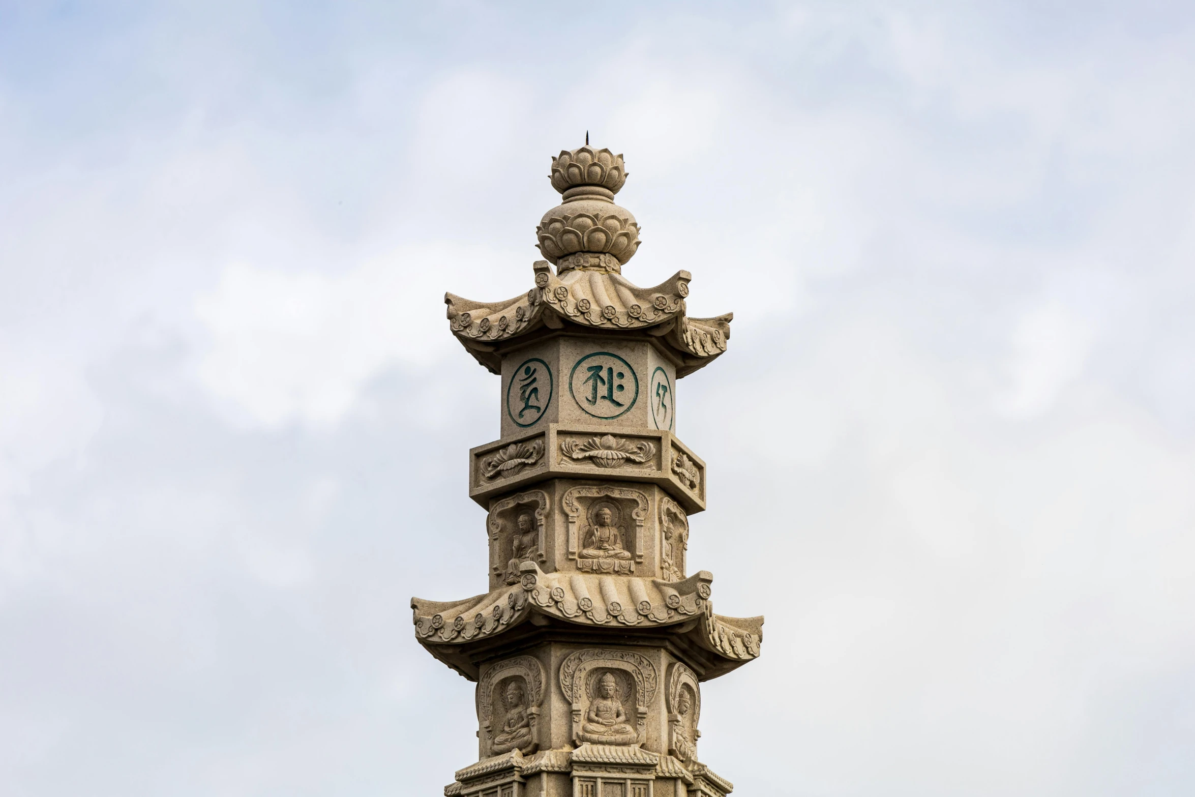 a clock tower on a cloudy day, looking up