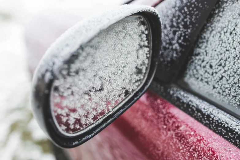 some snow is on the windows of a car