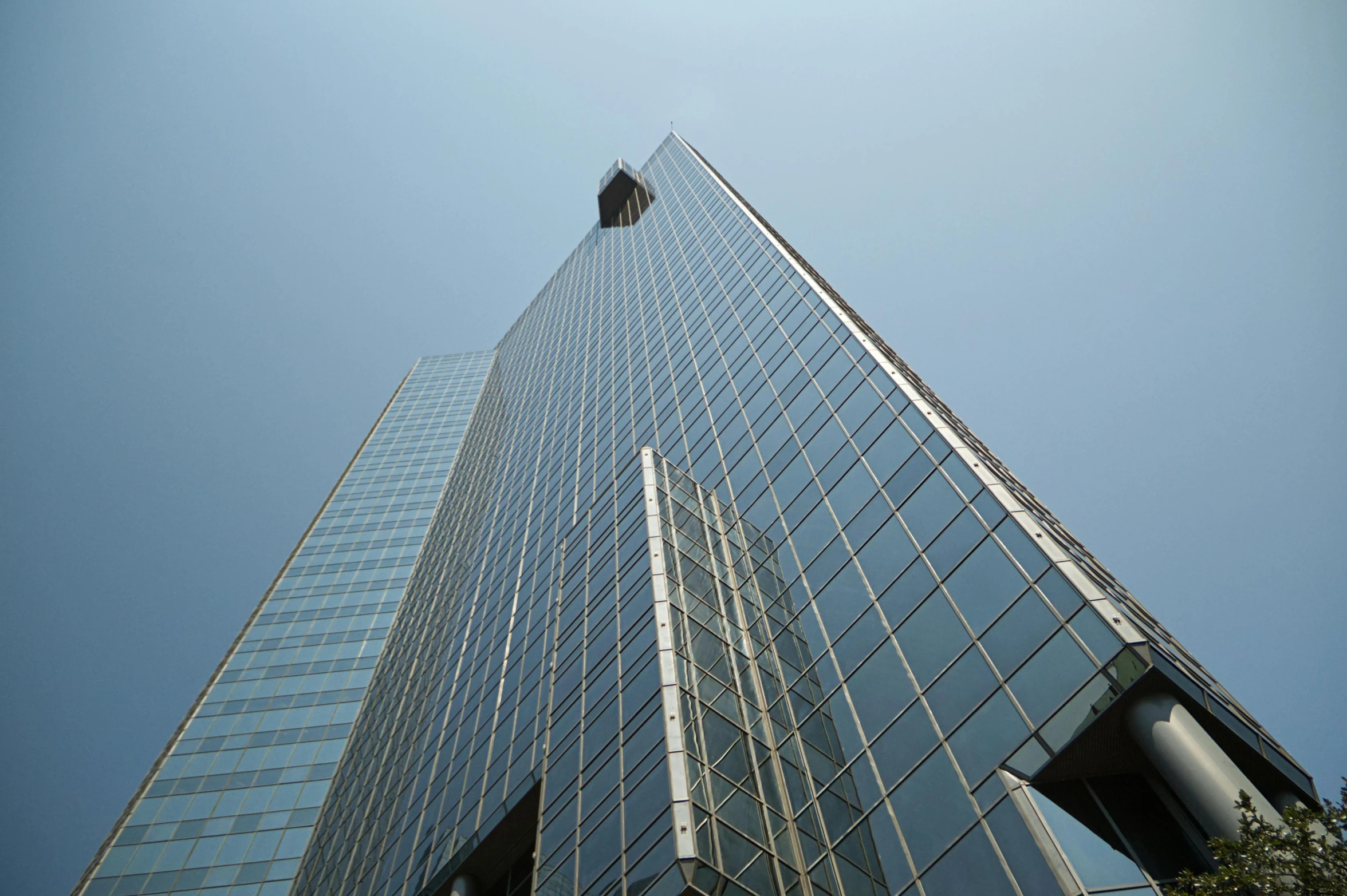 the top of an office building with an employee in a window washing