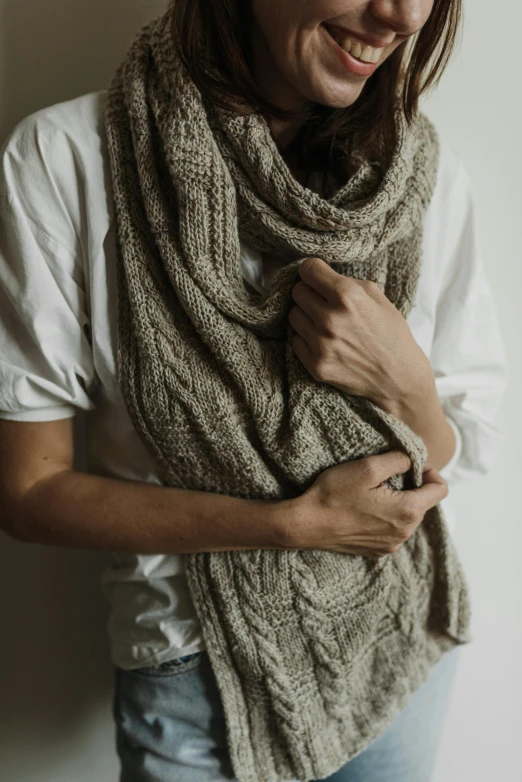 a woman is wearing a scarf around her neck