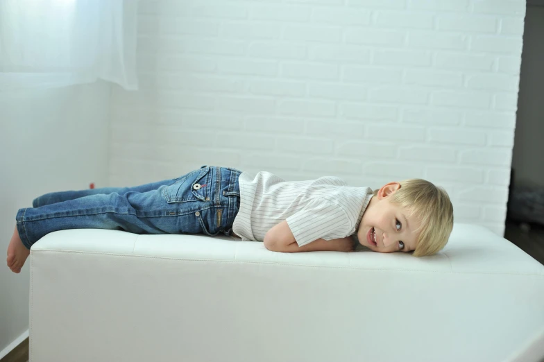 a  laying on top of a white couch