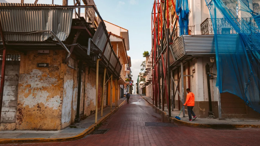 a person in a red jacket walking down an empty street