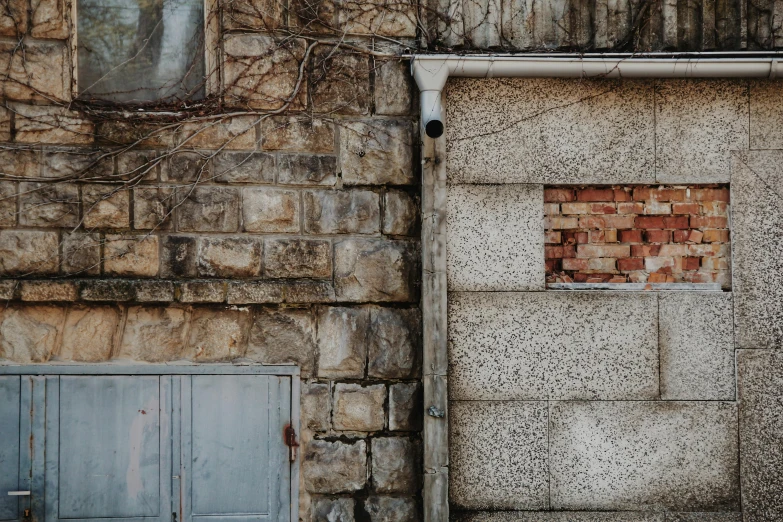 a red and yellow door sits next to a brick wall