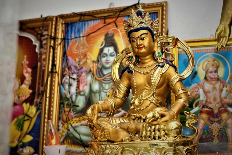 a gold buddha statue sitting on a table