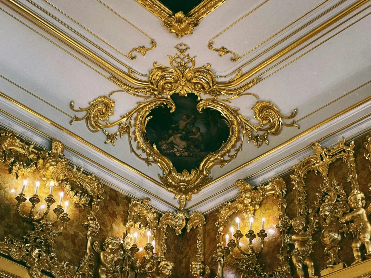 gold - trimmed wall and gilded ceiling in an elegant room