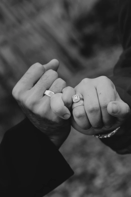 two people in love holding hands on their wedding day