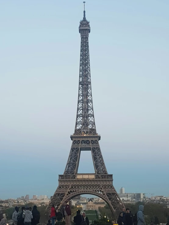 a number of people walking around a tall structure