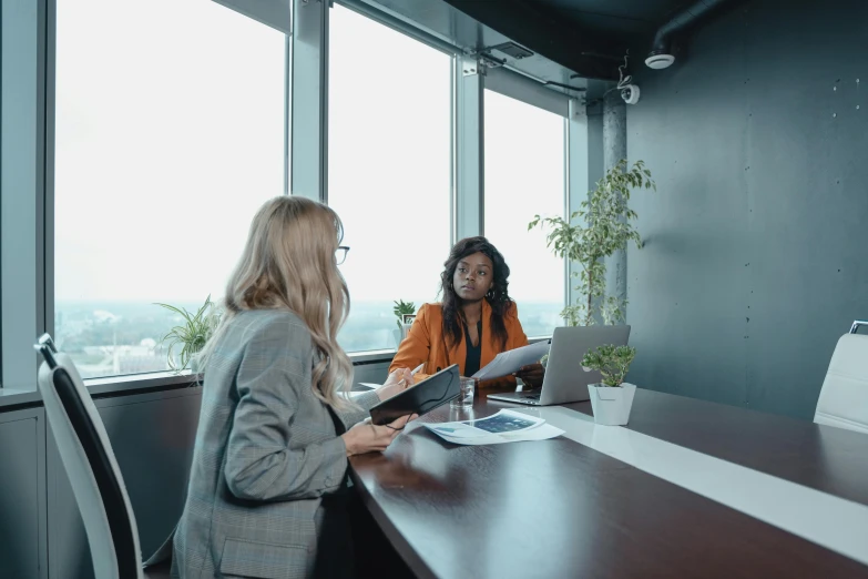 two women talking in an office