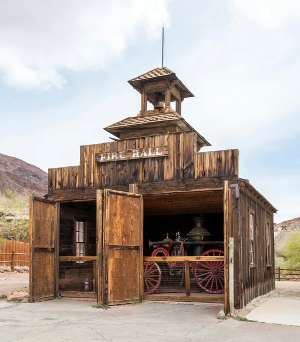 the inside of a small wooden building with a wheel attached