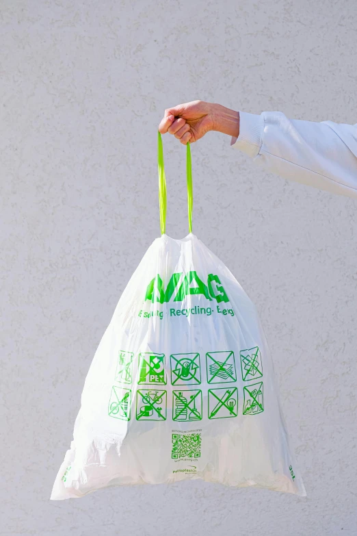 a person is holding a bag with many symbols