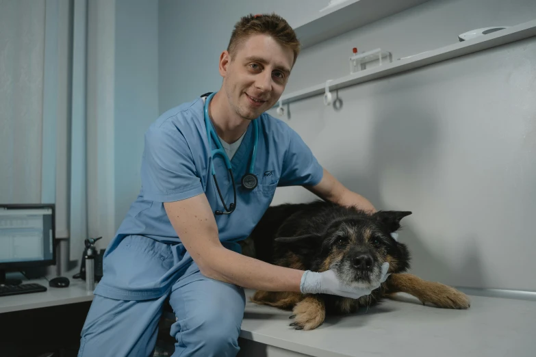 a veterinaerina is holding the arm of his dog