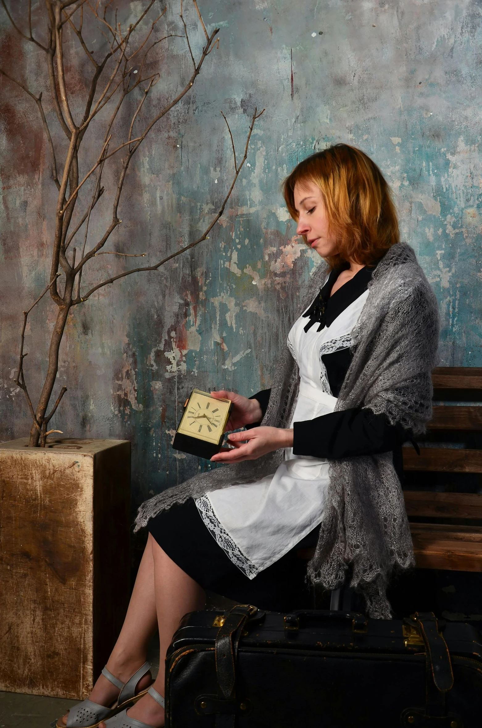 a woman sitting on a bench looking at her picture