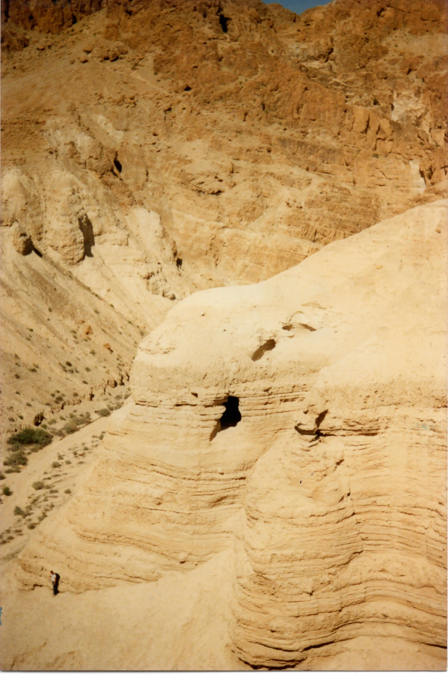 a man is in a black piece of water near a mountain