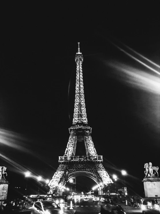 the eiffel tower is lit up at night