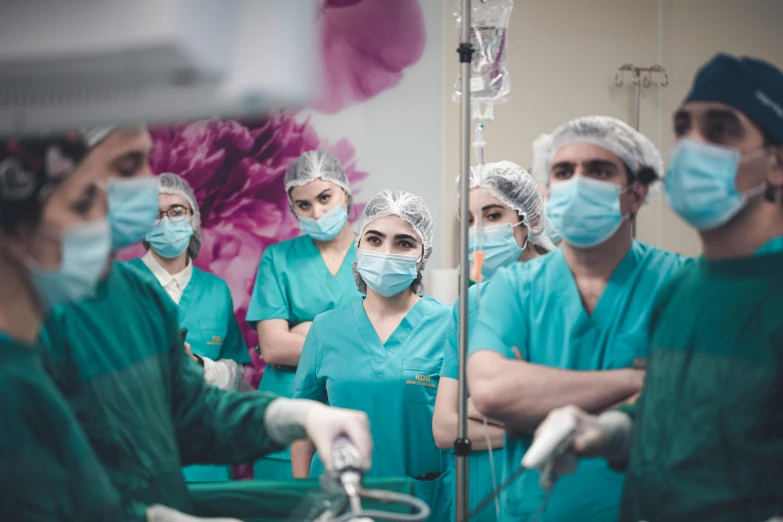 a group of doctors wearing masks are in a operating room