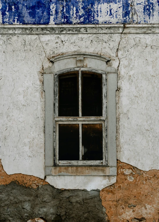 an old bricked window sits on a building