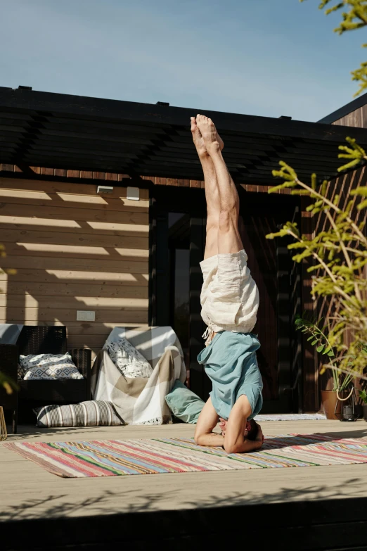 a man does a handstand while standing on his hands