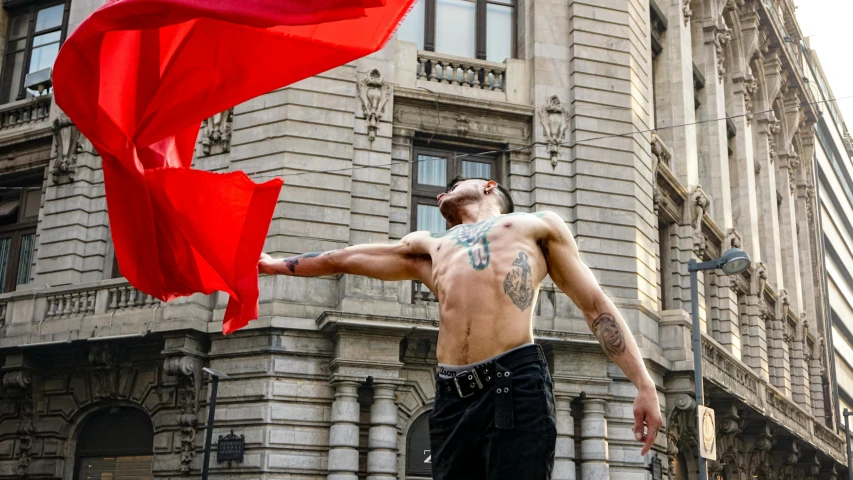 the man in the underwear is holding an umbrella