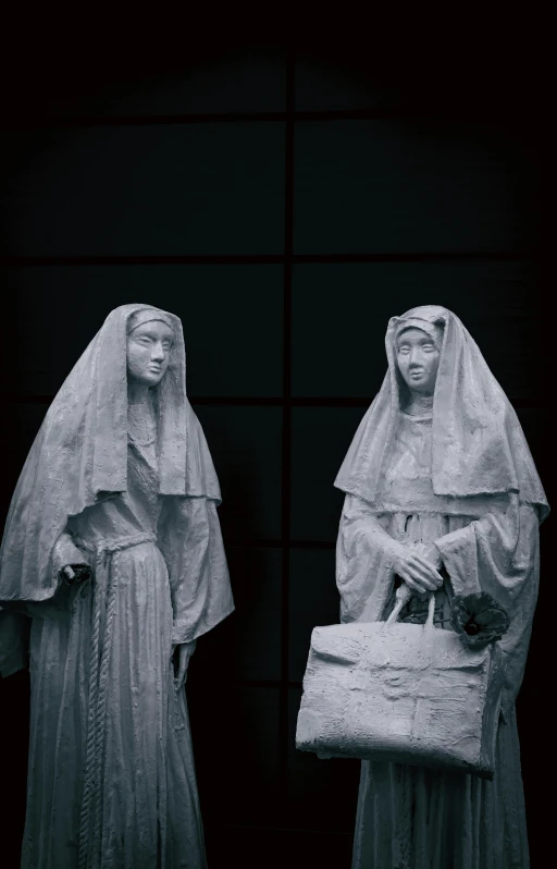 two statues of women dressed in costumes