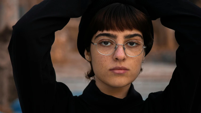 a girl with glasses covering her head