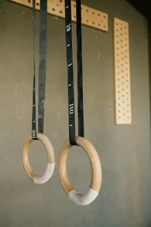 several pieces of wood hanging from hooks on wall