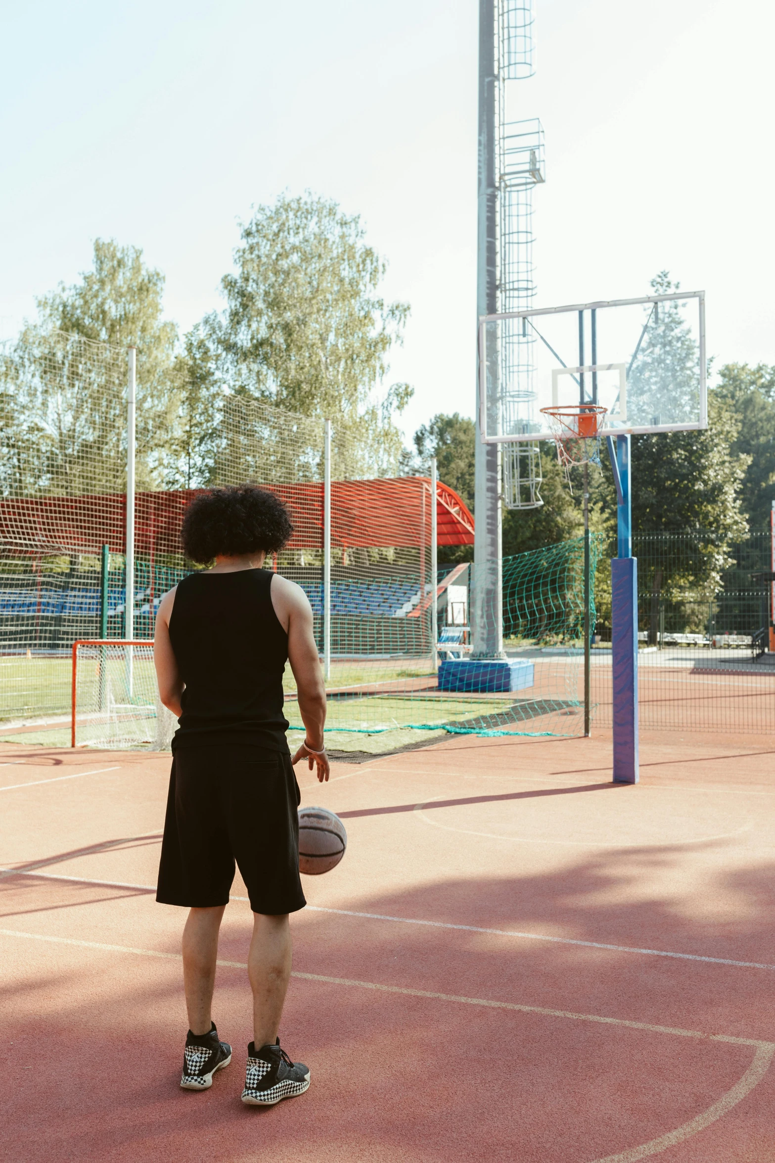 there is a young man that is holding a basketball on the court