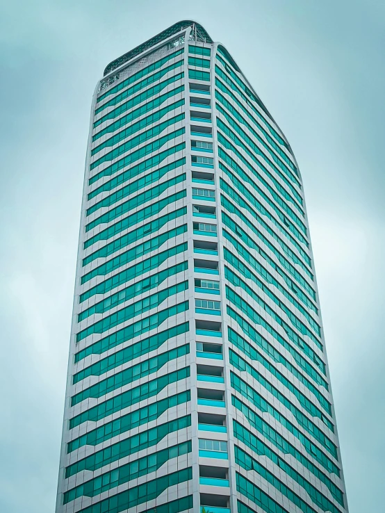 a tall building that is in front of a cloudy sky