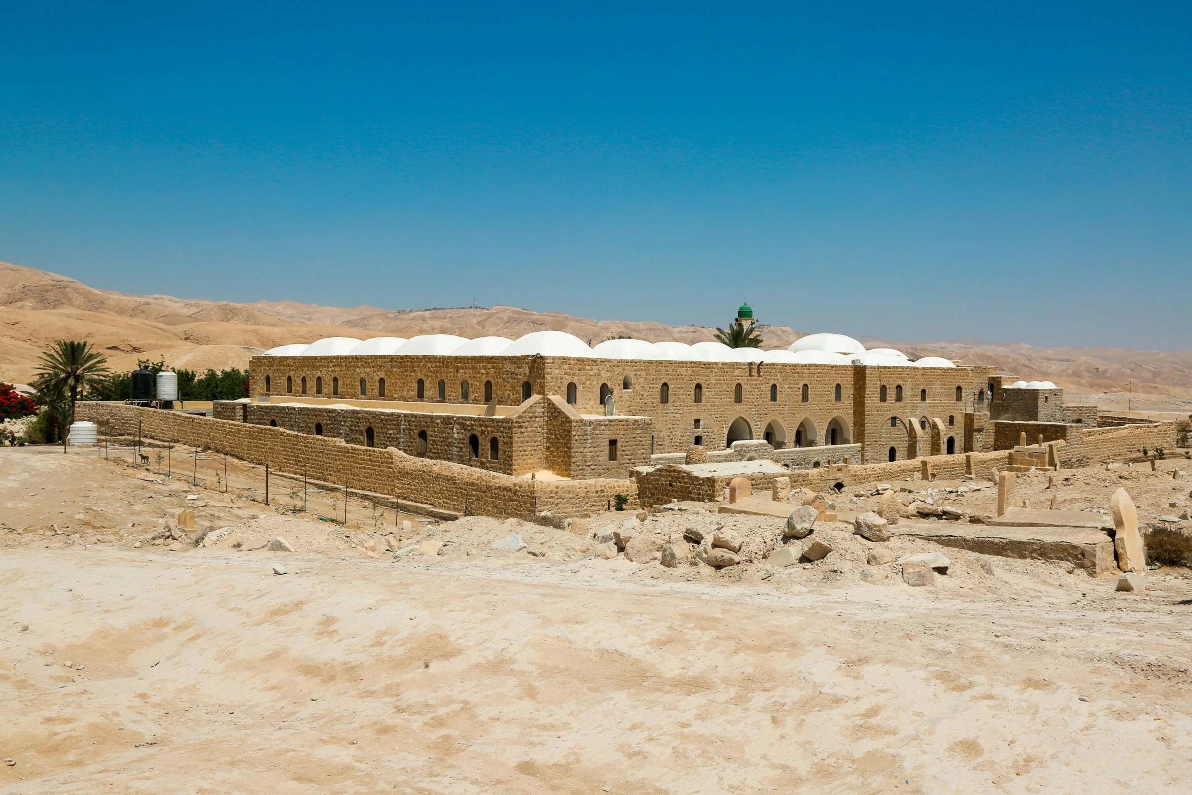 a stone building sitting on top of a sandy beach