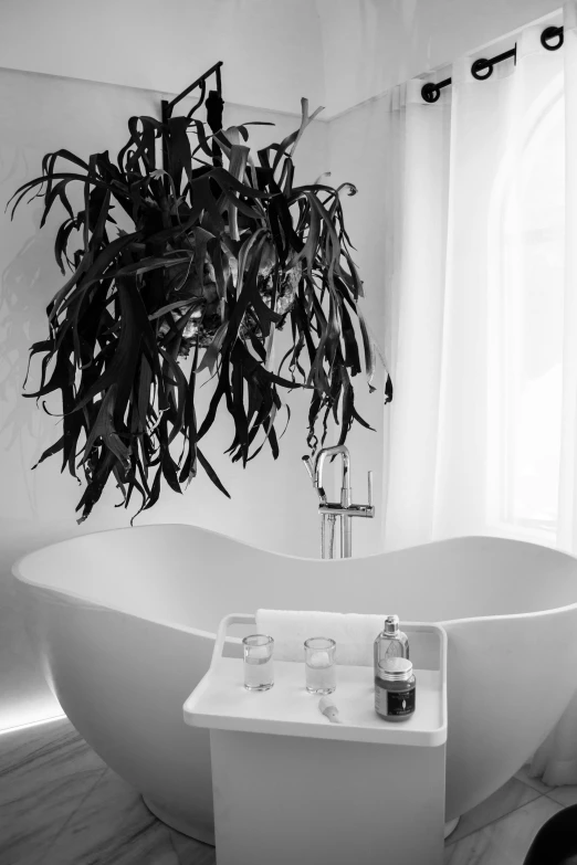 a white bath tub sitting in a bathroom next to a window