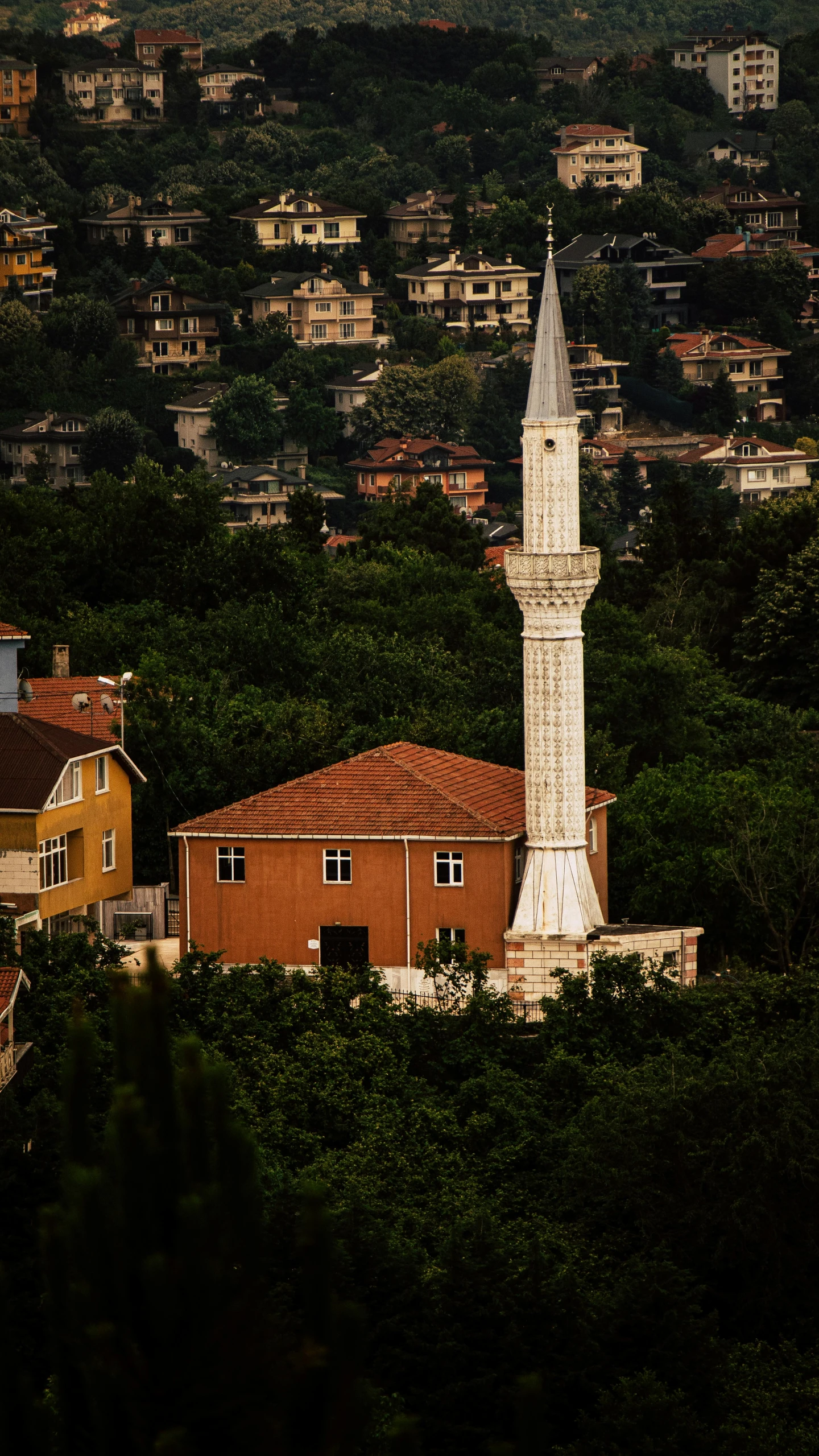 a white building with a tower on top of a hill