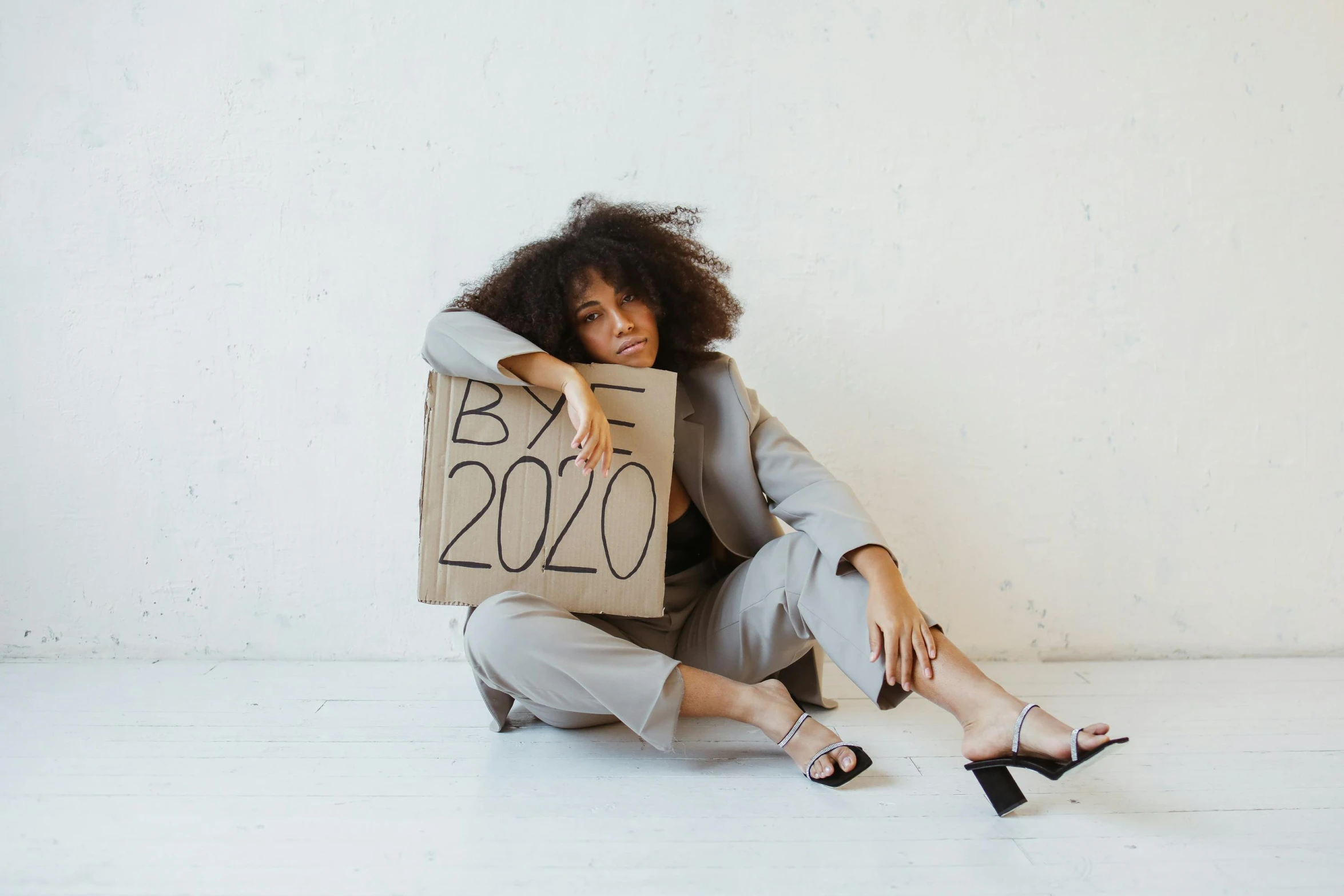 a woman is holding up a sign in a room