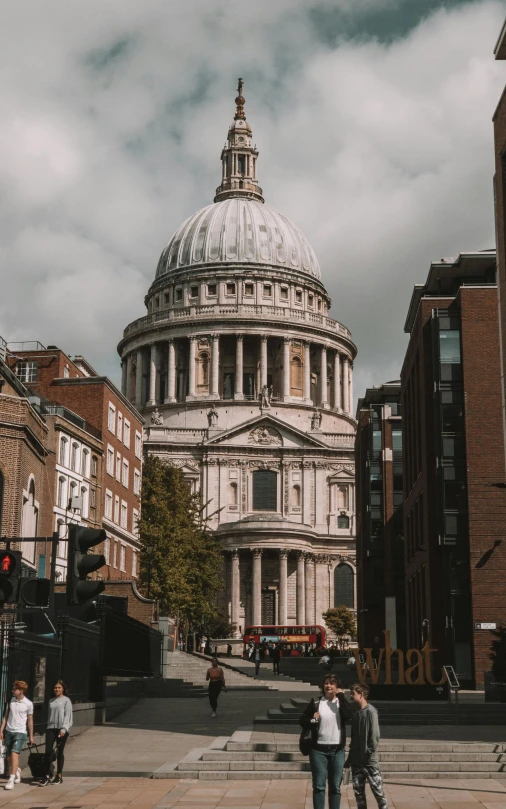 some buildings and people walking around on a cloudy day