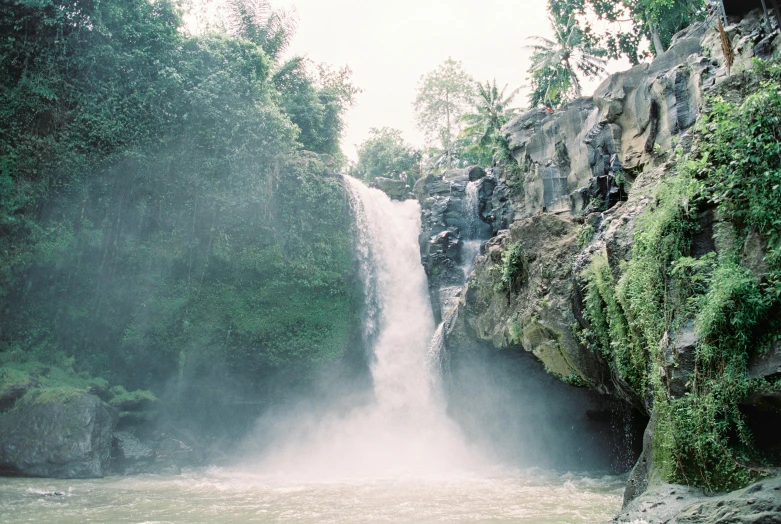 a large waterfall coming out of the side of a cliff