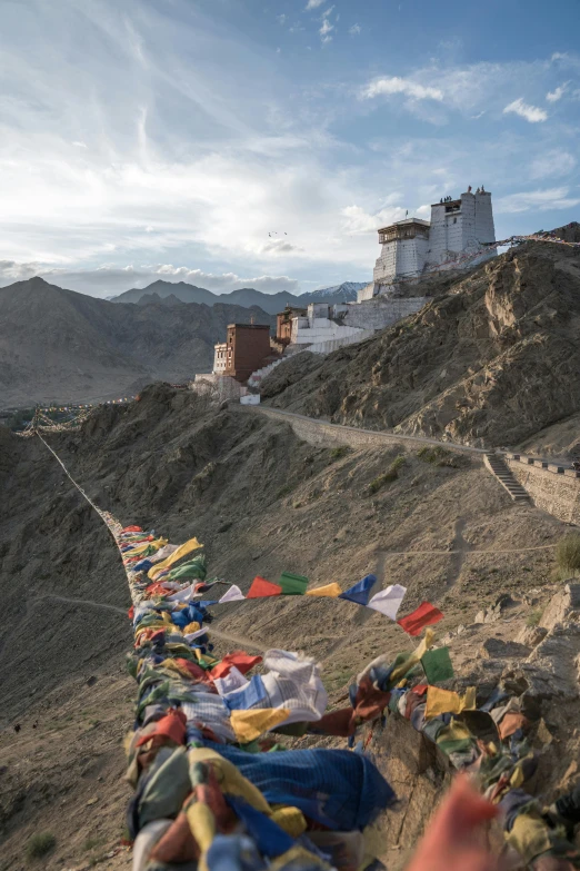 a long row of flags tied to a mountain